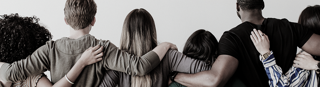 Rearview of diverse people hugging each other